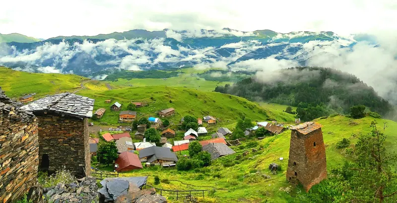 Slate towers above a Tusheti village and clouded valleys